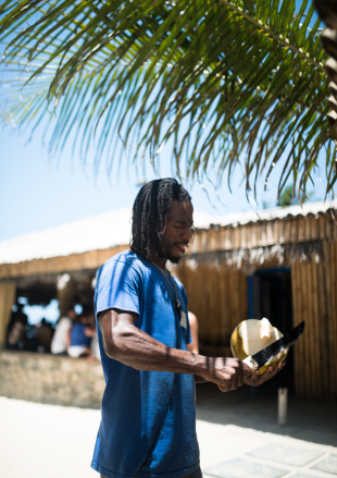 Image of a man chopping a coconut