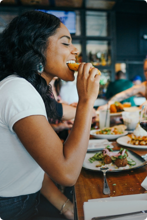 Image of a lady eating at a restuarant