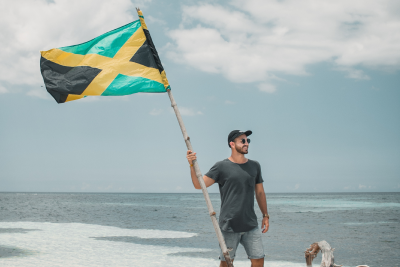 Image of a man holding a Jamaican flag